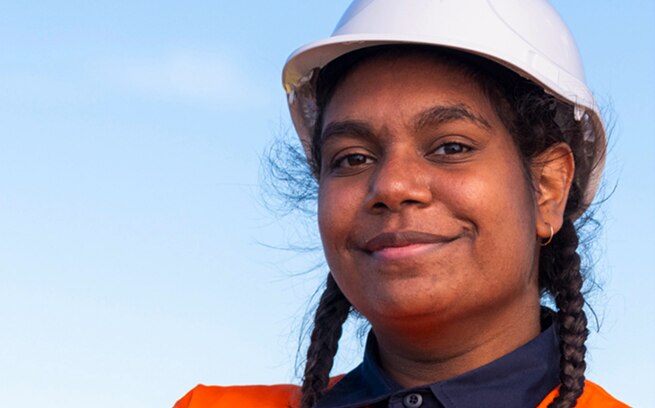 Close up of smiling woman in hard hat and orange hi-vis